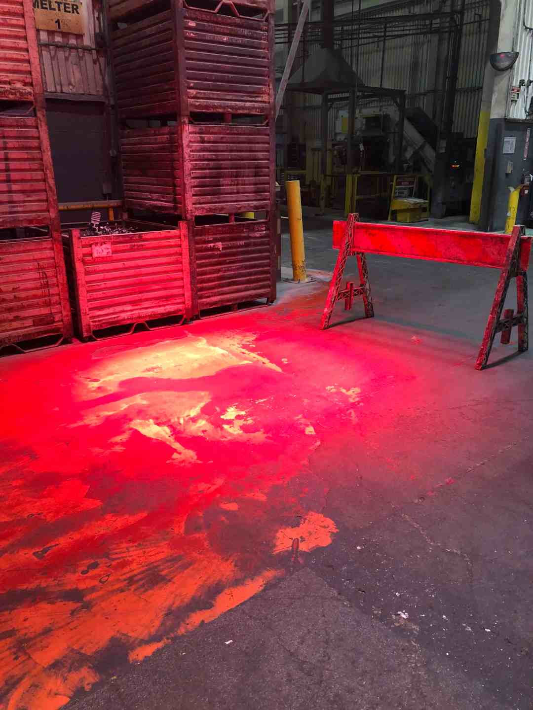High-contrast red light projected onto the warehouse floor